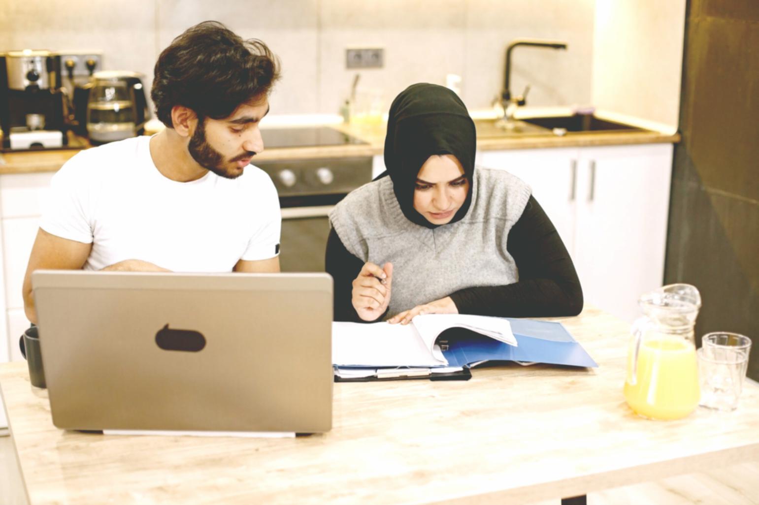 Participants working through practical budgeting exercises in pairs during a hands-on financial planning session